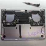Liquid-damaged 16-inch MacBook Pro logic board being inspected at LapFix